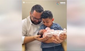 Father and son meet their baby daughter + sister